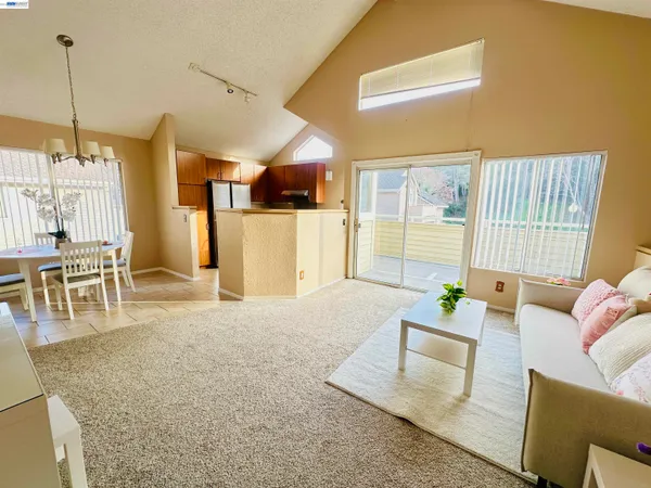 a living room with furniture and a floor to ceiling window