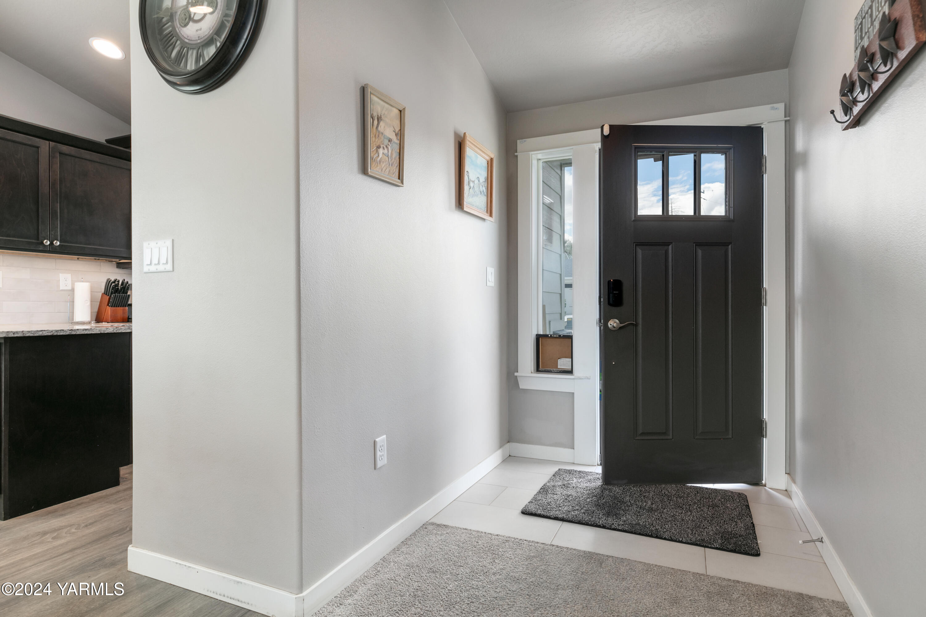 6210 Cottonwood Road Yakima, WA 98903 - Photo 3 of 18 a view of a hallway with wooden floor and a living room
