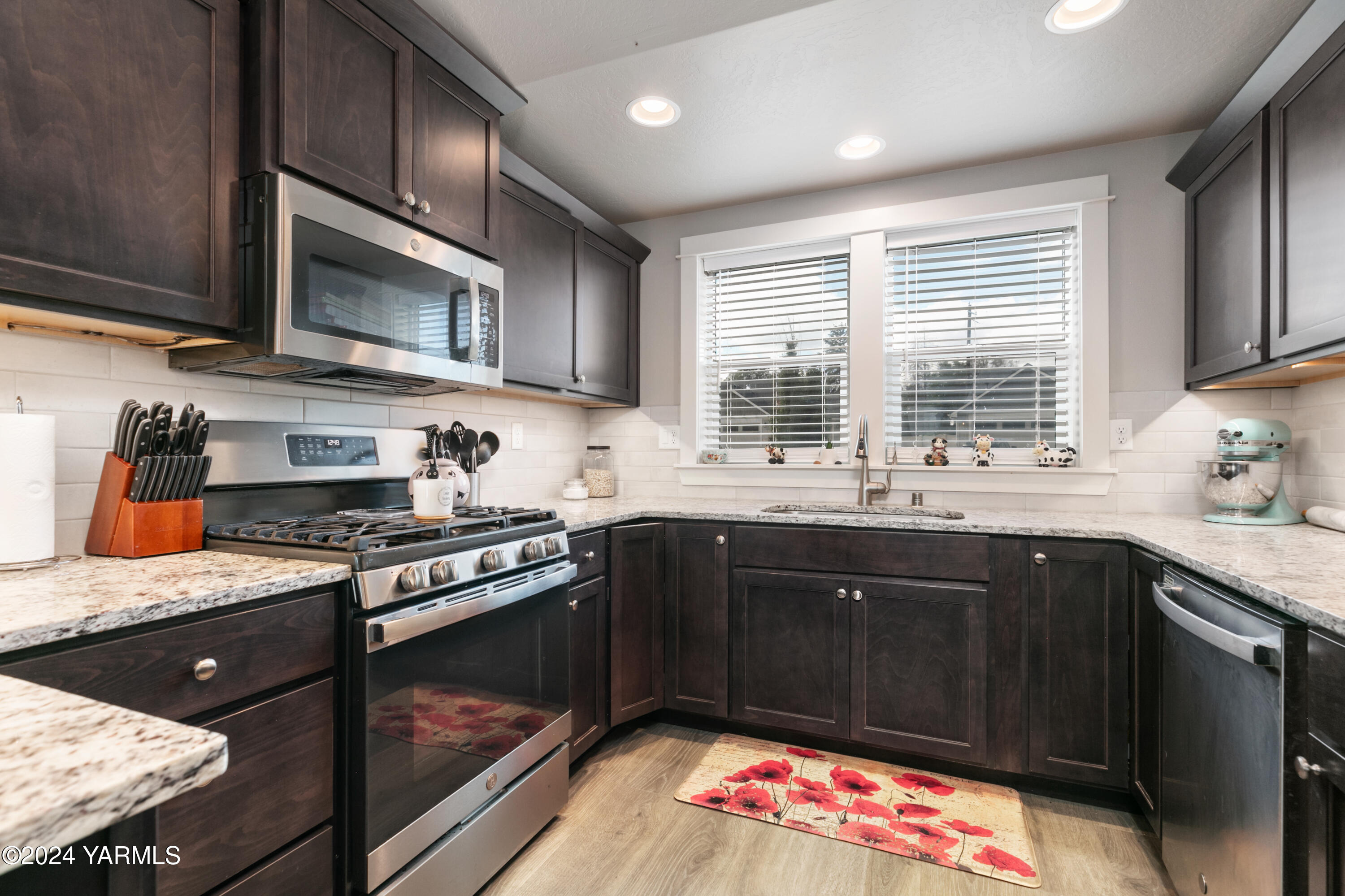 6210 Cottonwood Road Yakima, WA 98903 - Photo 6 of 18 a kitchen with stainless steel appliances granite countertop a sink stove and cabinets