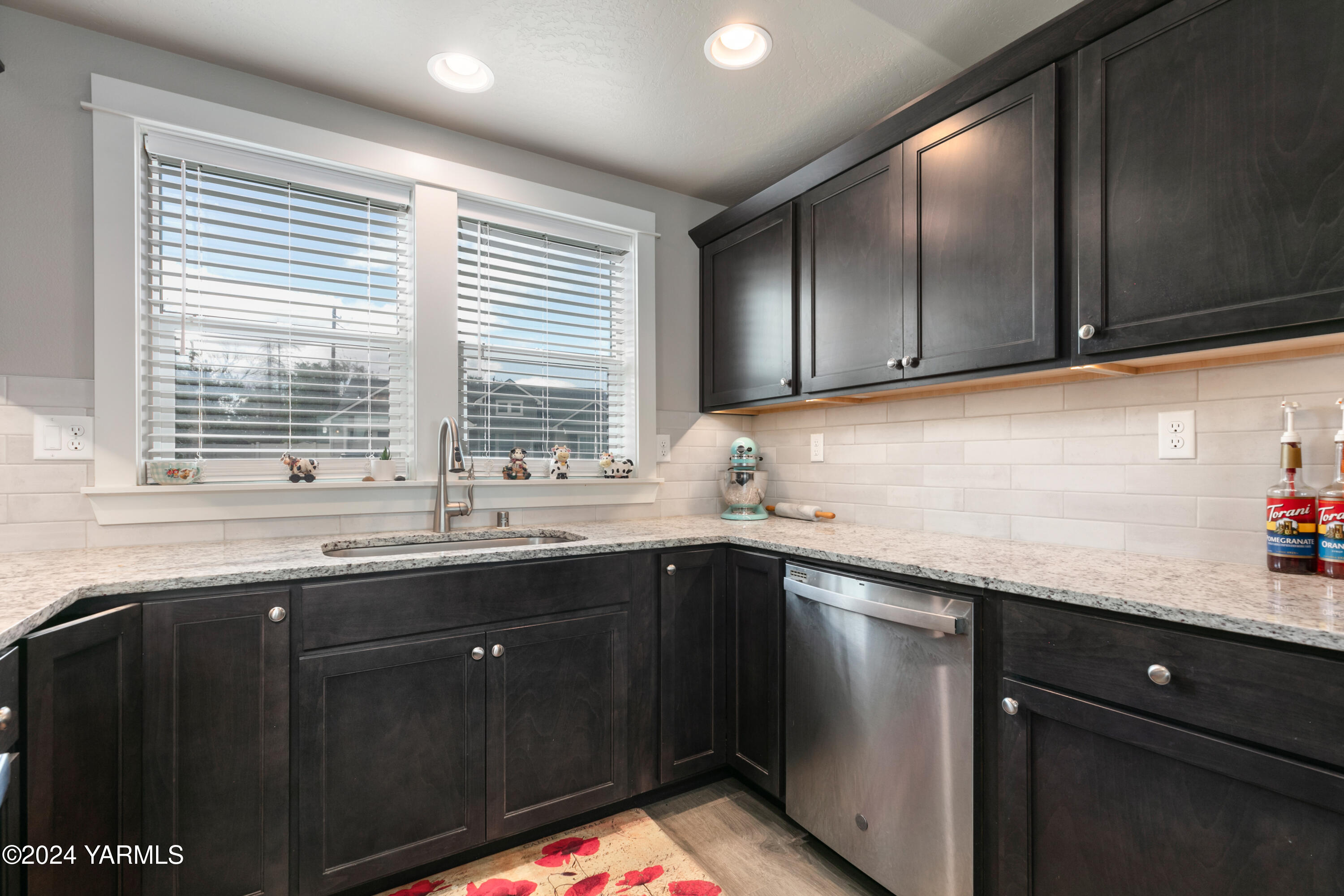 6210 Cottonwood Road Yakima, WA 98903 - Photo 7 of 18 a kitchen with granite countertop sink a window and cabinets