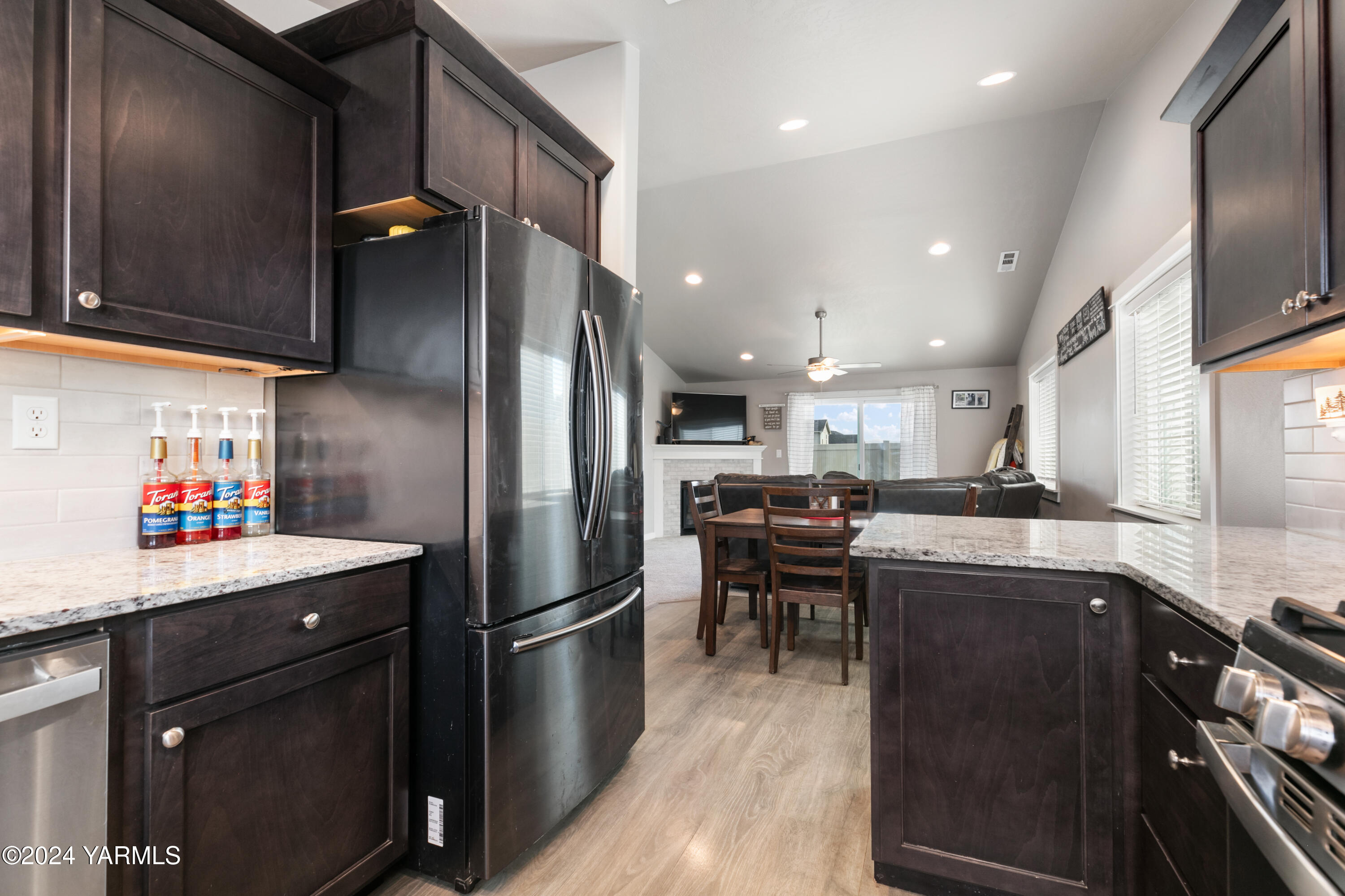 6210 Cottonwood Road Yakima, WA 98903 - Photo 8 of 18 a kitchen with stainless steel appliances granite countertop a refrigerator a sink a stove and cabinets