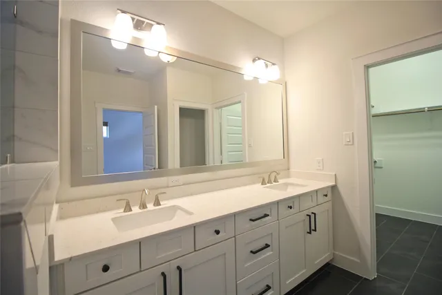 a bathroom with double sink and a mirror