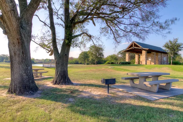 a front view of a building with trees