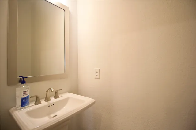 a bathroom with a sink a mirror and vanity