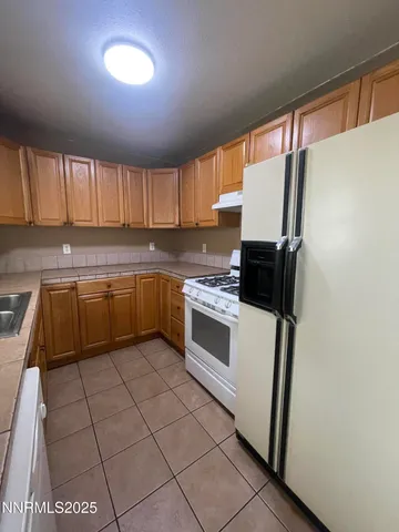 a kitchen with a stove a sink and a refrigerator