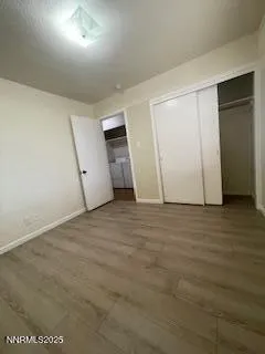 an empty room with wooden floor and white doors