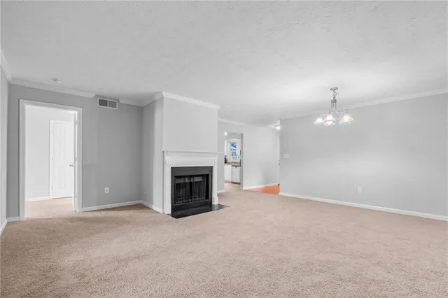 an empty room with fireplace and fan