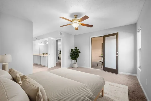 a bedroom with a large bed and ceiling fan