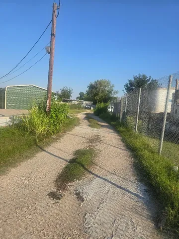 a view of a pathway with a yard