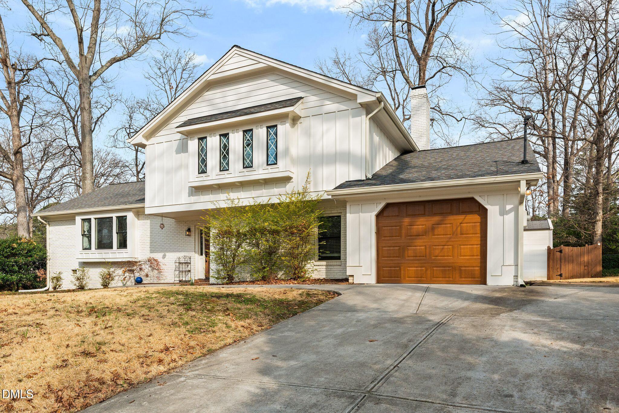 1201 Chardon Court Raleigh, NC 27609 - Photo 1 of 47 a front view of a house with a yard and garage
