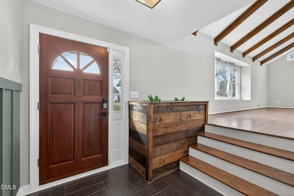 a view of entryway and hall with wooden floor