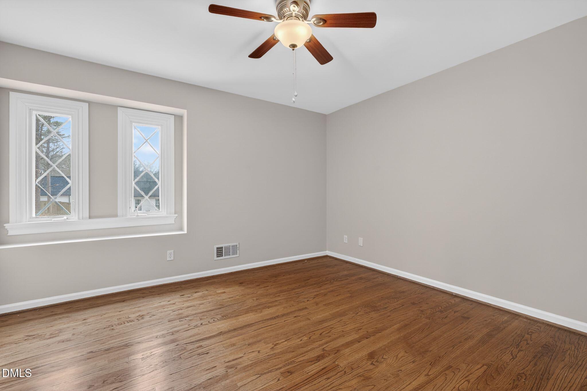 1201 Chardon Court Raleigh, NC 27609 - Photo 19 of 47 a view of an empty room with window and wooden floor
