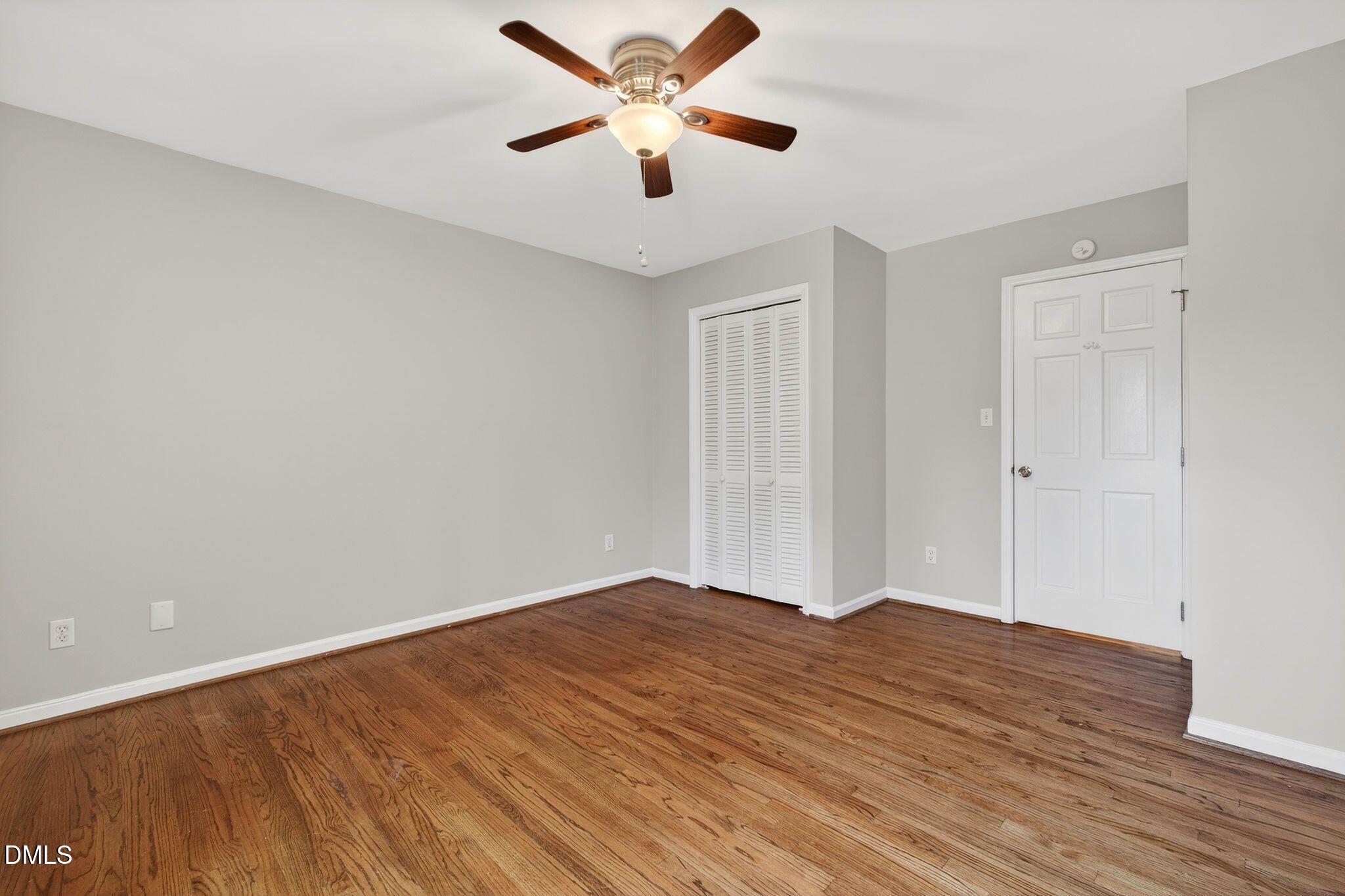 1201 Chardon Court Raleigh, NC 27609 - Photo 20 of 47 a view of a room with wooden floor and a ceiling fan