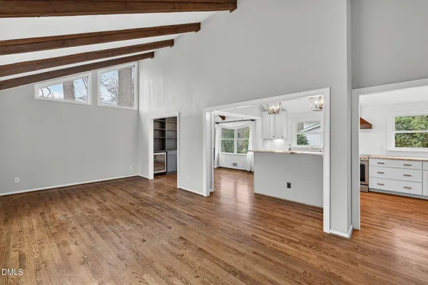 a view of a kitchen with wooden floor and windows
