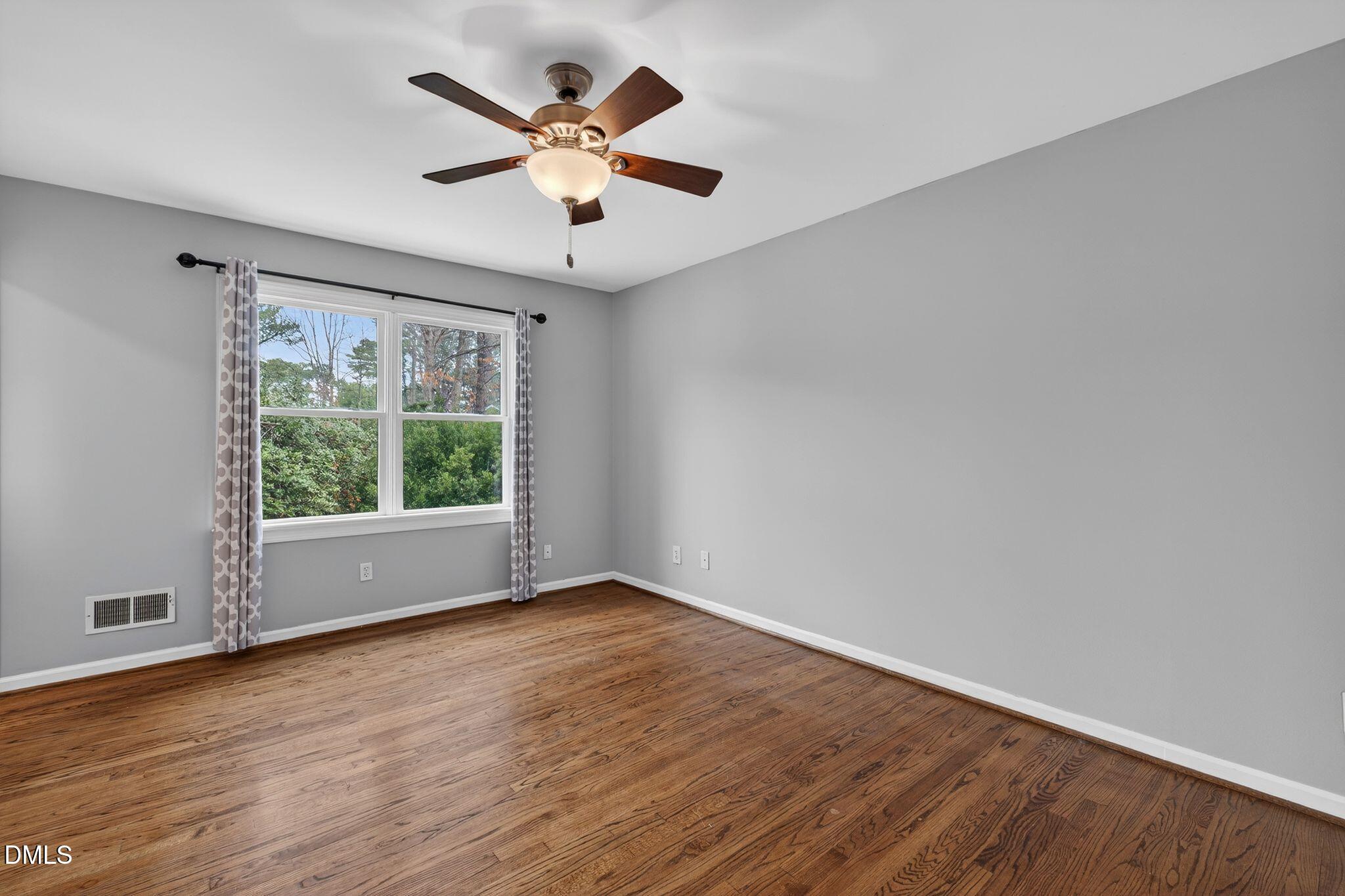 1201 Chardon Court Raleigh, NC 27609 - Photo 21 of 47 an empty room with wooden floor and windows