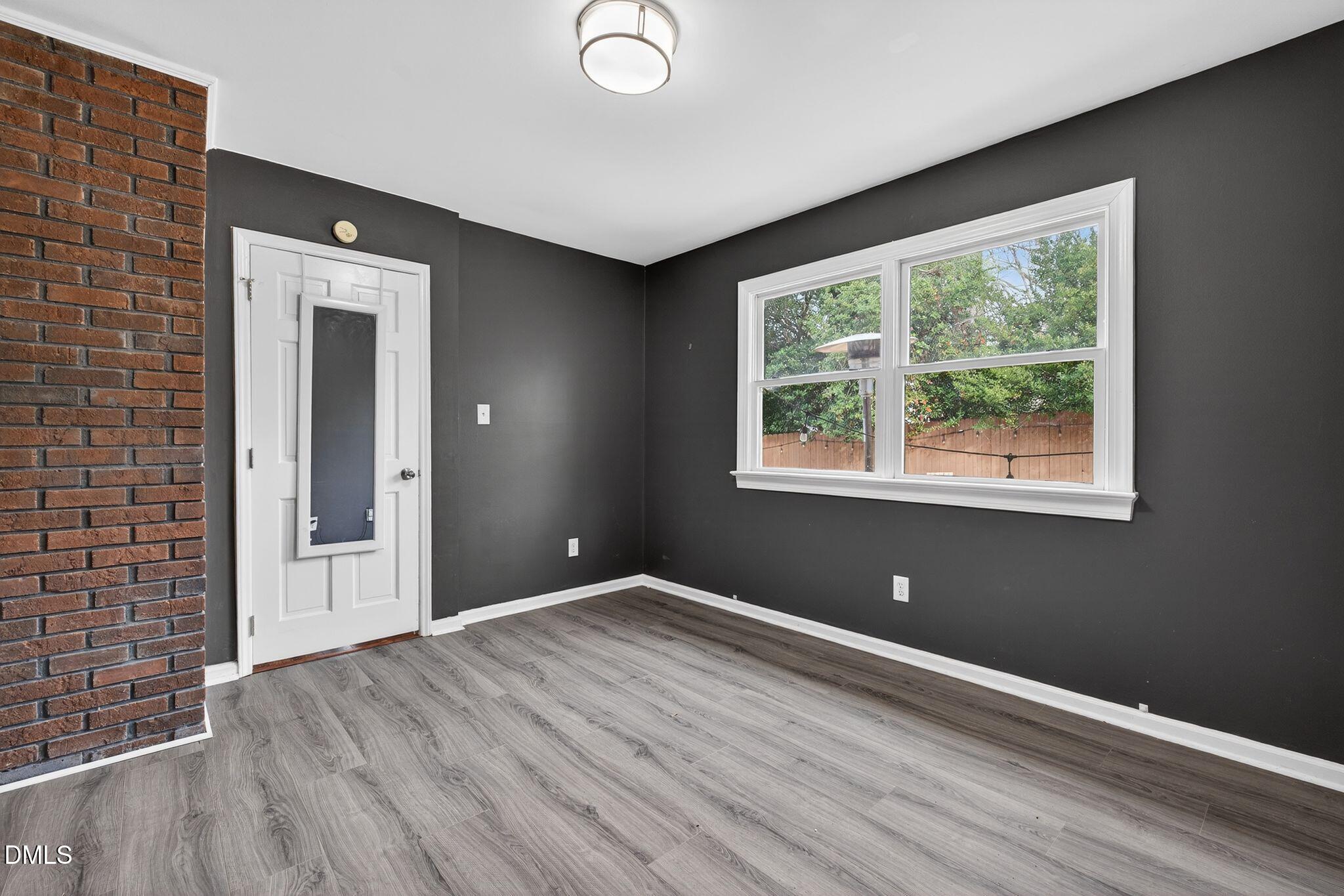 1201 Chardon Court Raleigh, NC 27609 - Photo 28 of 47 a view of an empty room with wooden floor and a window