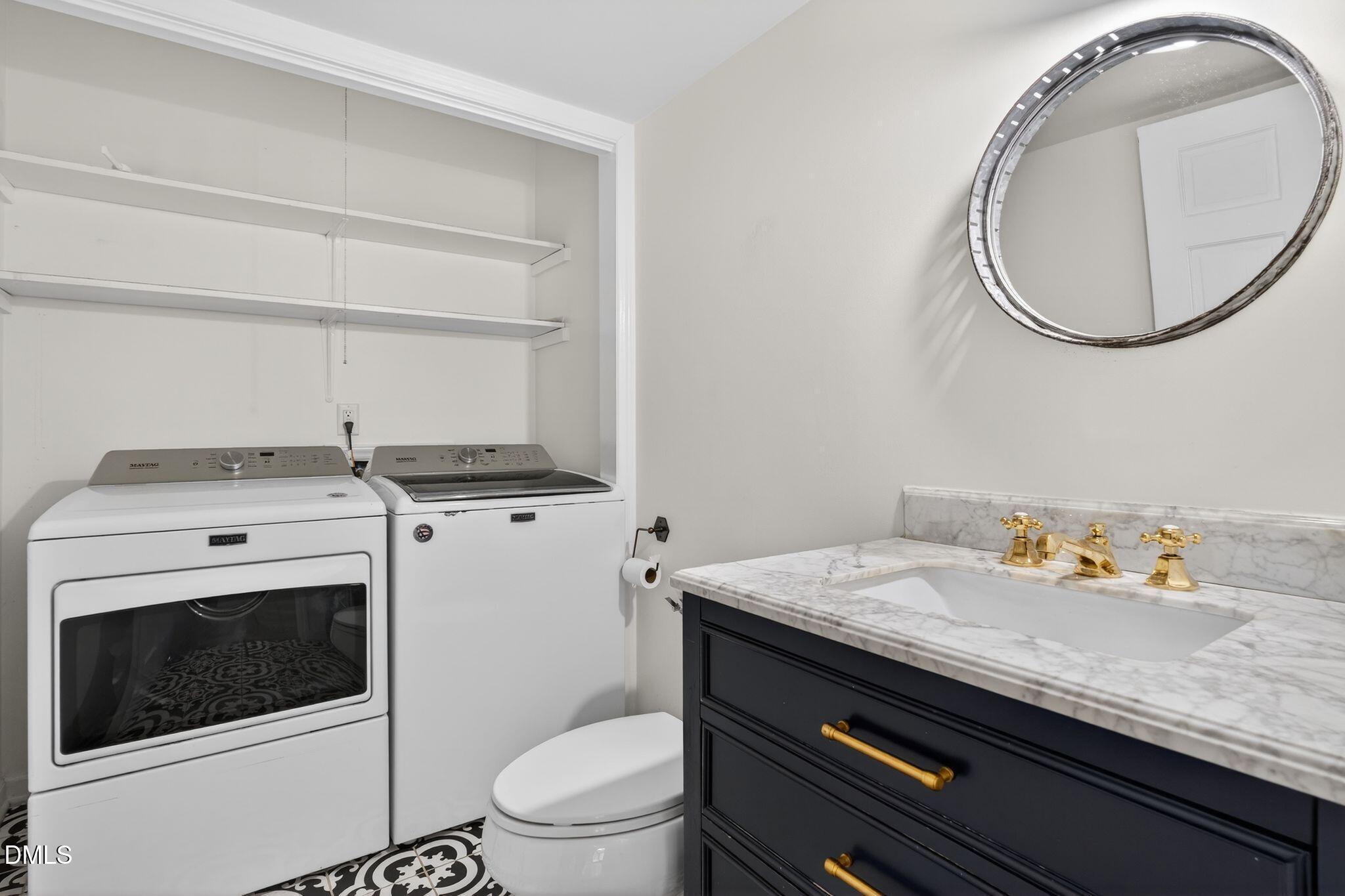 1201 Chardon Court Raleigh, NC 27609 - Photo 29 of 47 a bathroom with a sink a toilet and a mirror