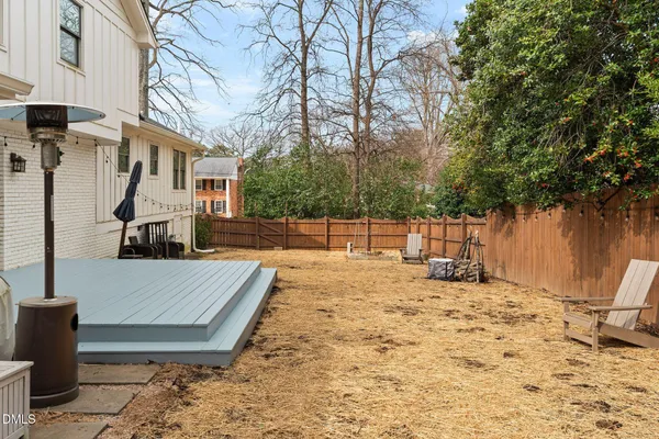 a view of a backyard with a tree