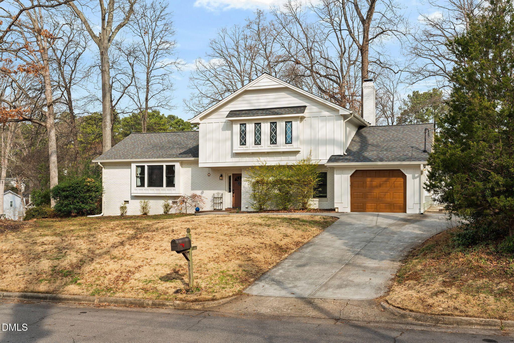 1201 Chardon Court Raleigh, NC 27609 - Photo 41 of 47 a front view of a house with a yard and garage
