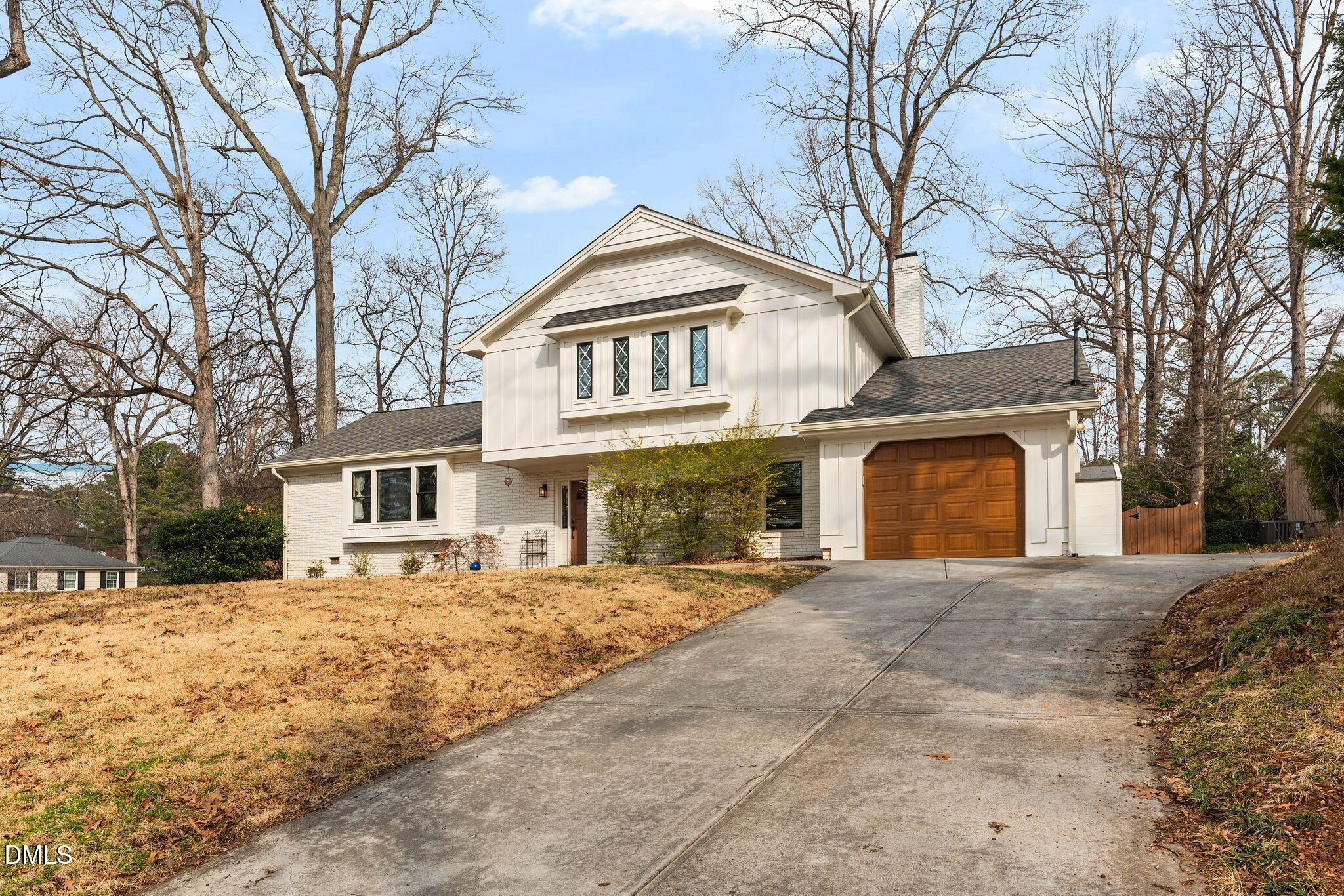 1201 Chardon Court Raleigh, NC 27609 - Photo 46 of 47 a front view of a house with a yard covered with snow