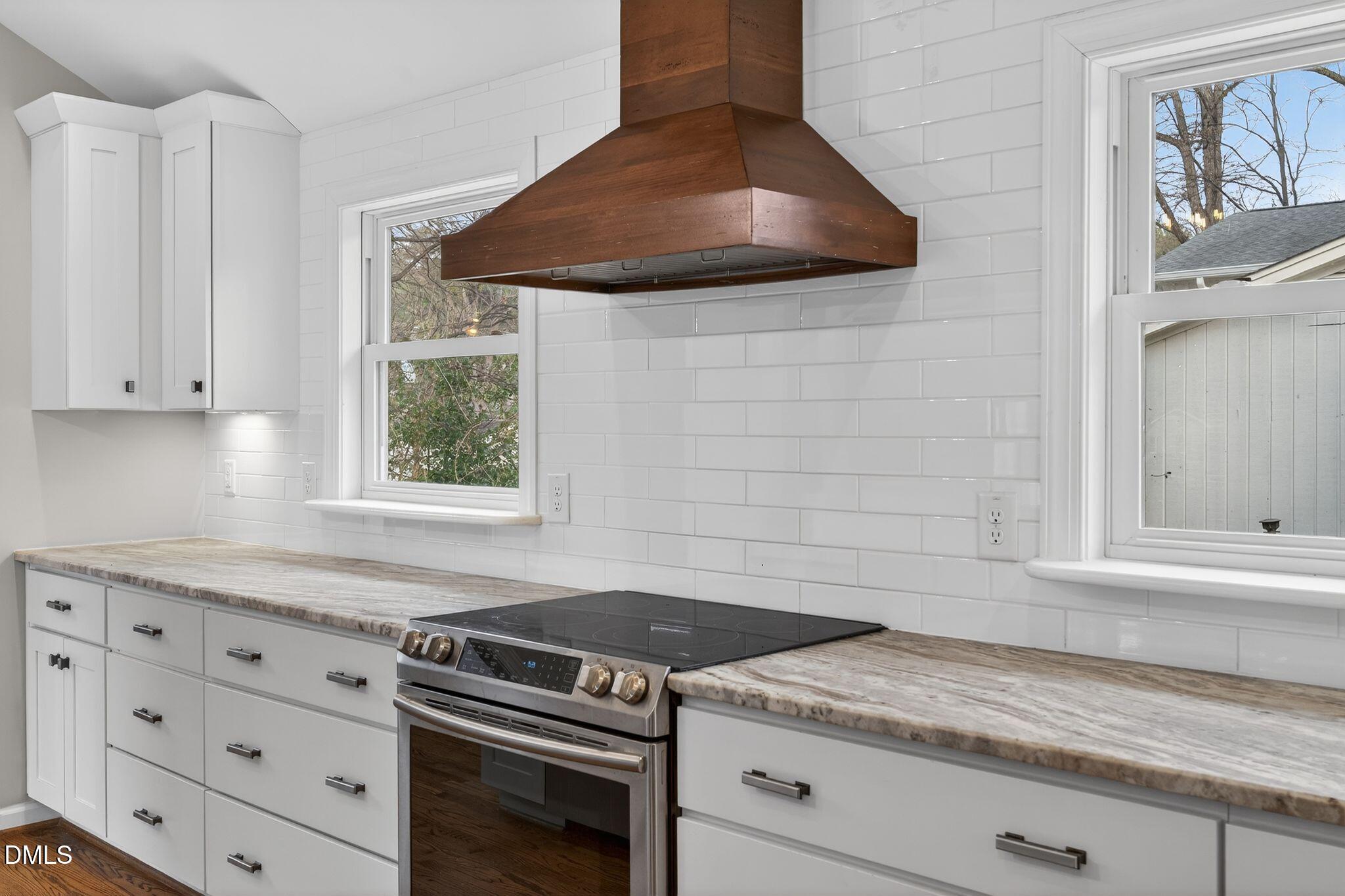 1201 Chardon Court Raleigh, NC 27609 - Photo 5 of 47 a kitchen with granite countertop a stove and a sink