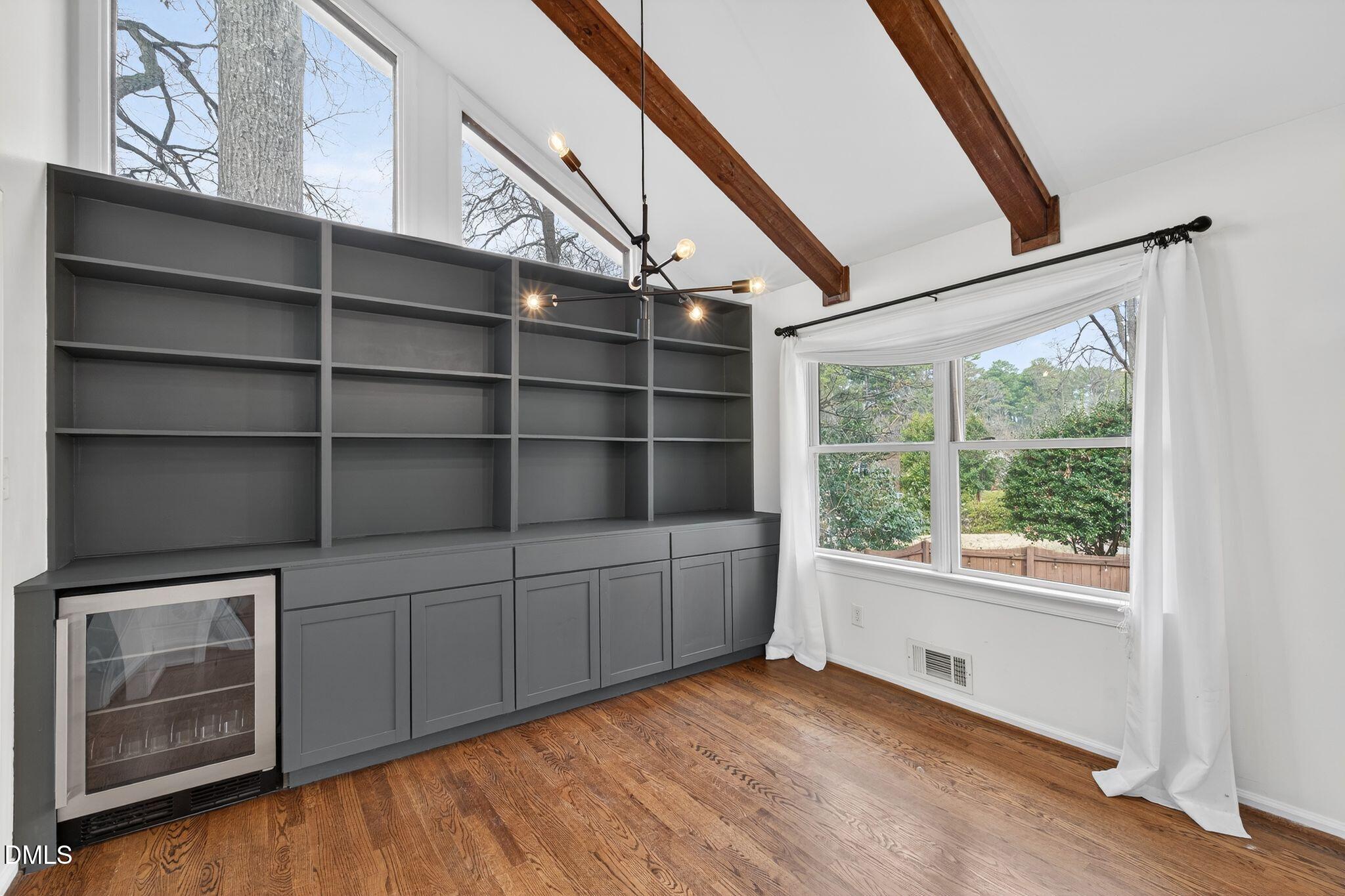1201 Chardon Court Raleigh, NC 27609 - Photo 8 of 47 a view of an empty room with a window and wooden floor