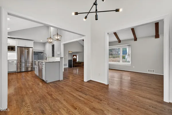 a view of a kitchen with a sink cabinet wooden floor and a kitchen view