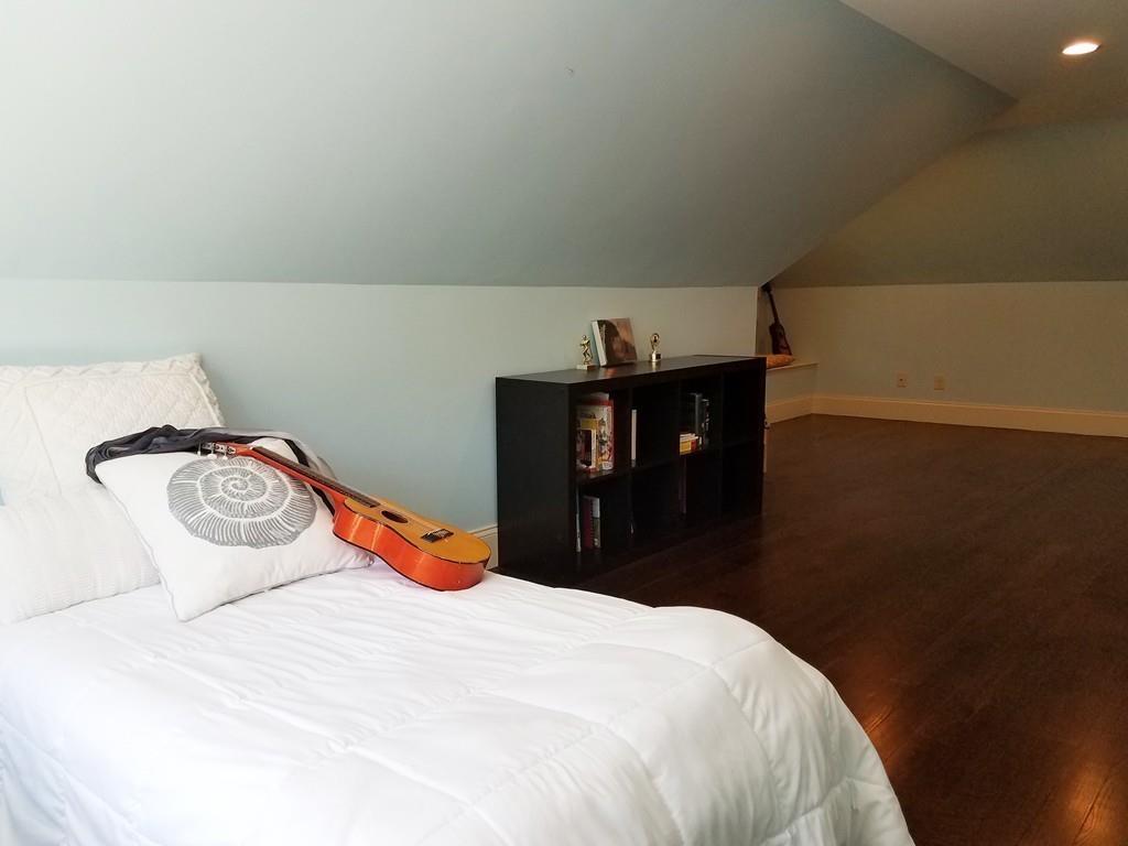 39 Bloomfield Street Lexington, MA 02421 - Photo 29 of 42 a bedroom with a bed and wooden floor
