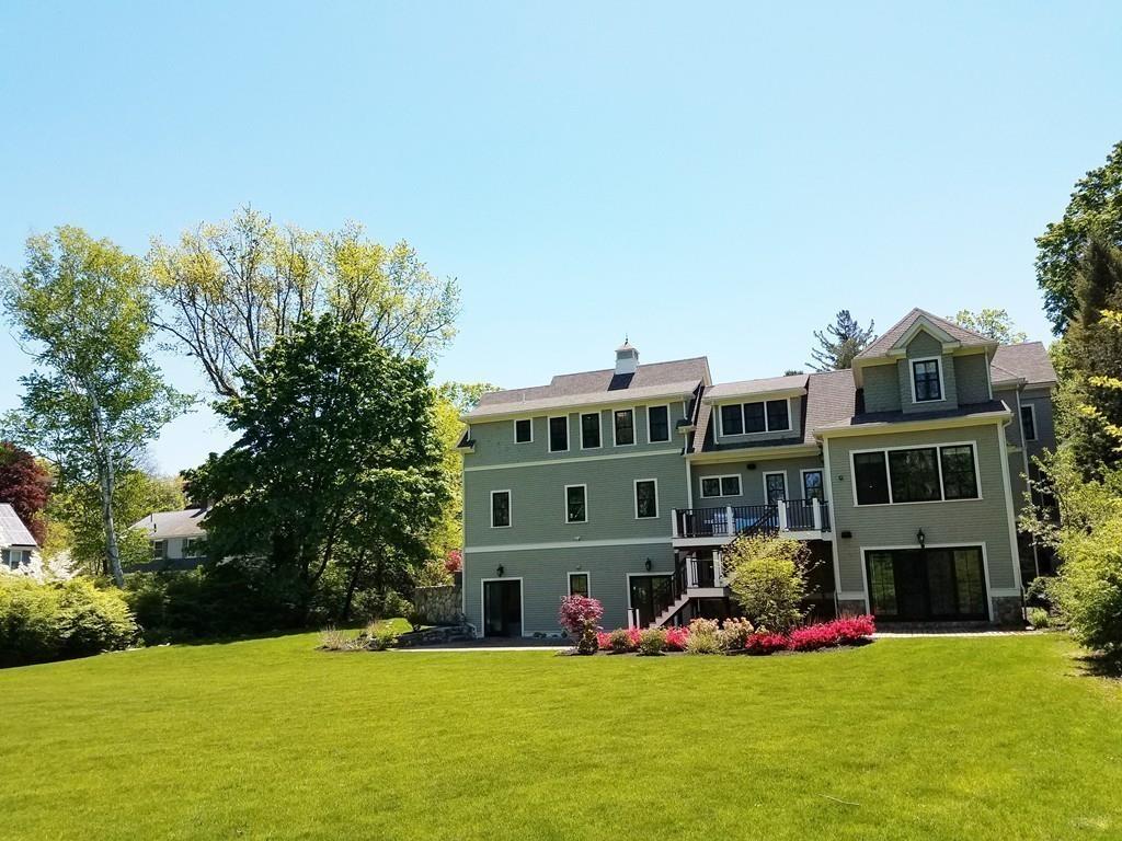39 Bloomfield Street Lexington, MA 02421 - Photo 37 of 42 a view of a house with a yard and sitting area