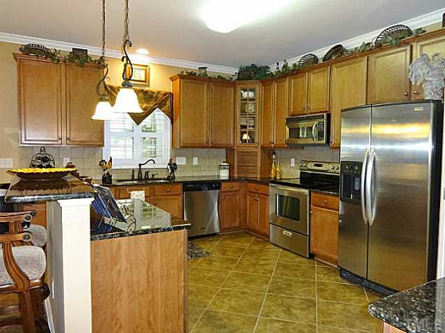 3212 Queensland Road Raleigh, NC 27614 - Photo 6 of 25 Prepare meals in this large kitchen. Stainless steel KitchenAid appliances, 18" porcelain tile, 42" maple cabinets, granite counter tops, walk-in pantry make cooking a breeze. Kitchen