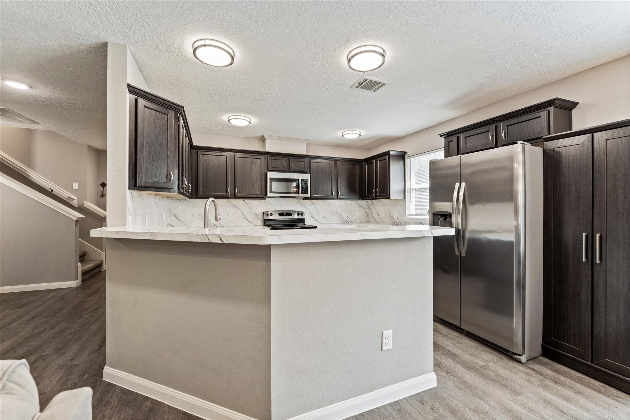 3998 Frontier Road Willis, TX 77378 - Photo 20 of 33 a kitchen with stainless steel appliances granite countertop a refrigerator and a stove