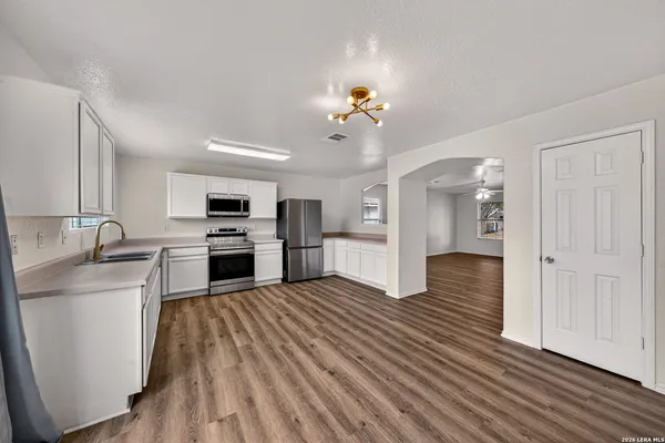 a view of kitchen with sink microwave and refrigerator