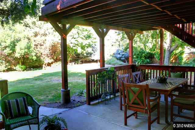 300 Cliff View Drive Reno, NV 89523 - Photo 3 of 9 a view of a wooden deck with chairs and a yard