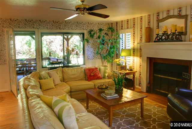 300 Cliff View Drive Reno, NV 89523 - Photo 5 of 9 a living room with furniture a fireplace and a floor to ceiling window