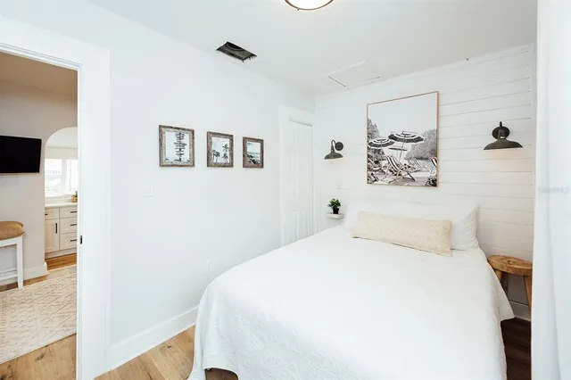 a bathroom with a toilet sink a mirror and vanity