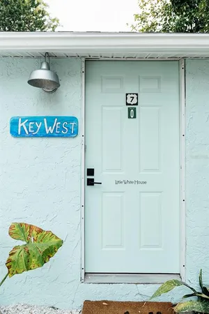 a view of a house with backyard porch and sitting area