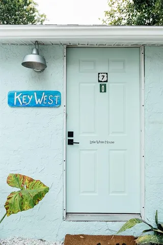 a view of a house with backyard porch and sitting area