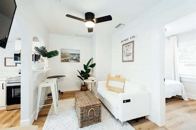 a bedroom with a bed a flat screen tv and a couch