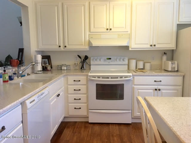 2016 Grant Place, Unit 9 Melbourne, FL 32901 - Photo 2 of 7 a kitchen with granite countertop white cabinets and white appliances