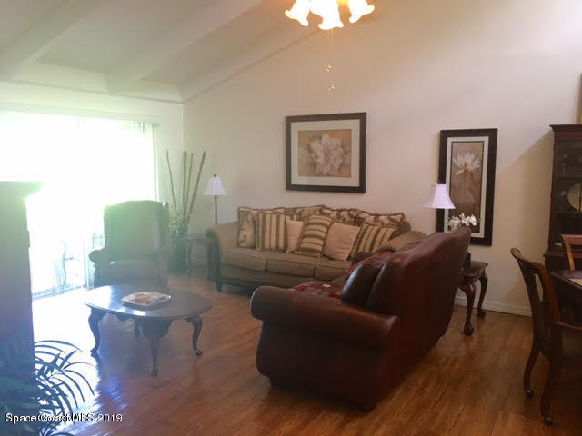 2016 Grant Place, Unit 9 Melbourne, FL 32901 - Photo 4 of 7 a living room with furniture and a flat screen tv