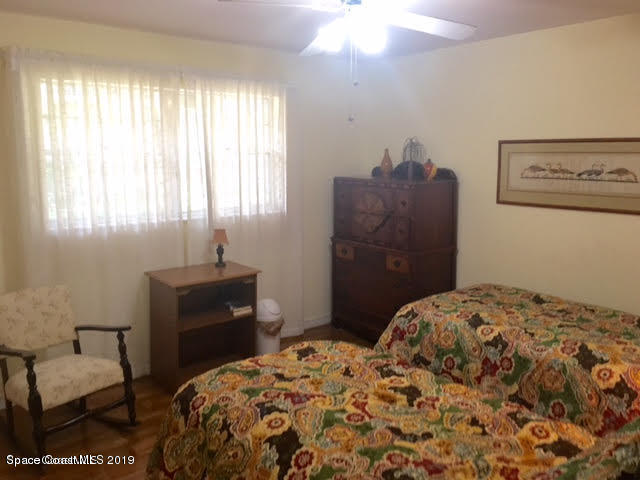 2016 Grant Place, Unit 9 Melbourne, FL 32901 - Photo 7 of 7 a bedroom with a bed and a dresser
