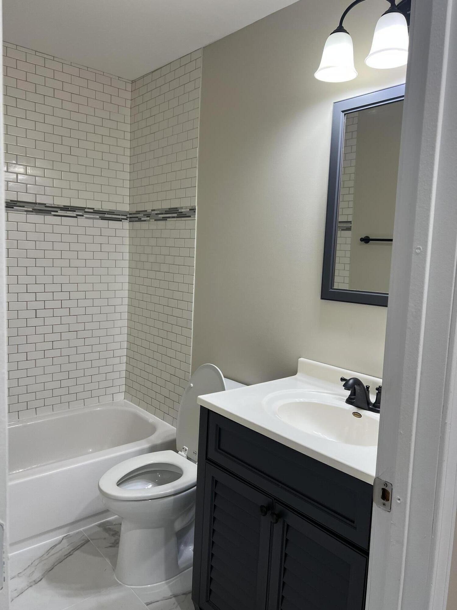 3851 Maple Street Hobart, IN 46342 - Photo 6 of 28 a bathroom with a sink a toilet and shower