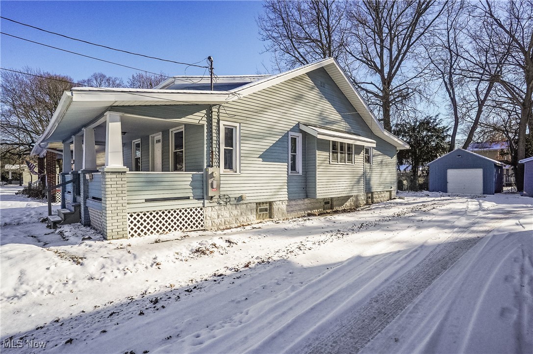 1618 Hampton Road Akron, OH 44305 - Photo 26 of 30 View of snowy exterior featuring an outbuilding, a porch, and a garage