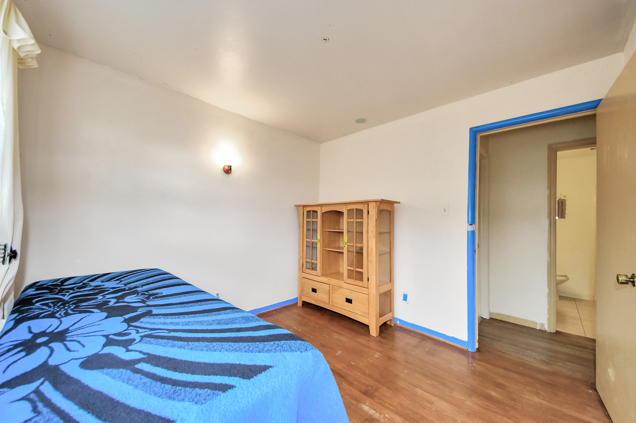 9701 Foredale Street Houston, TX 77075 - Photo 20 of 32 a bedroom with a bed and wooden floor