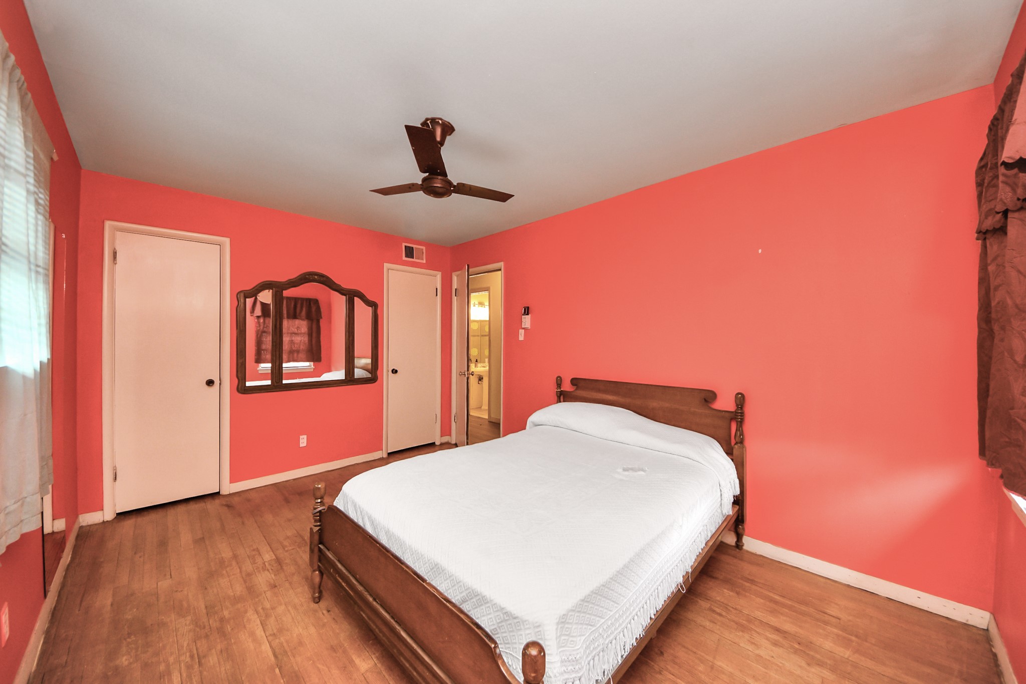 9701 Foredale Street Houston, TX 77075 - Photo 22 of 32 a bedroom with a large bed and a chandelier