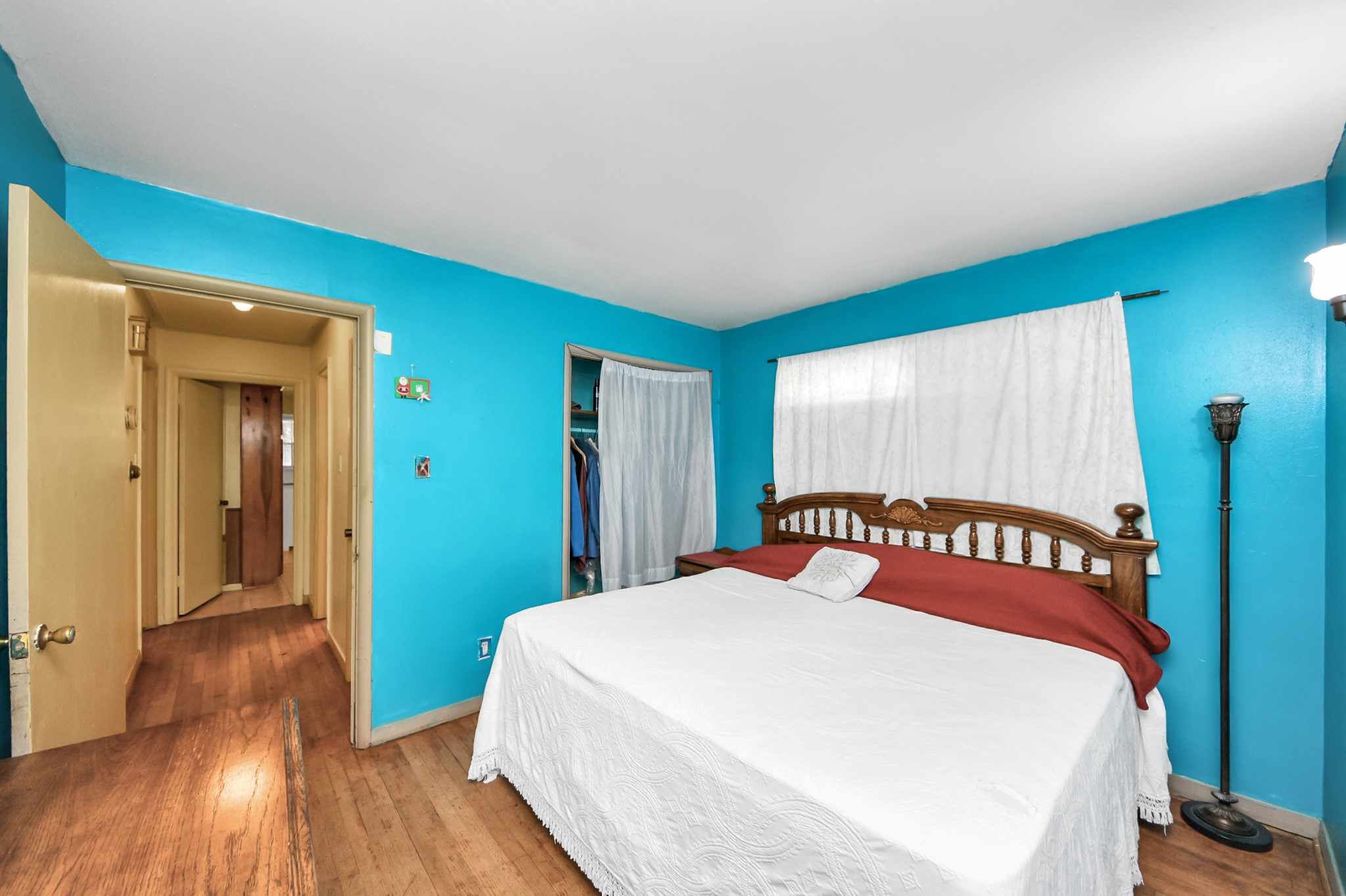 9701 Foredale Street Houston, TX 77075 - Photo 24 of 32 a bedroom with a large bed and a wooden floor