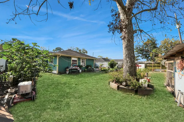 a view of a chair and table in backyard of the house