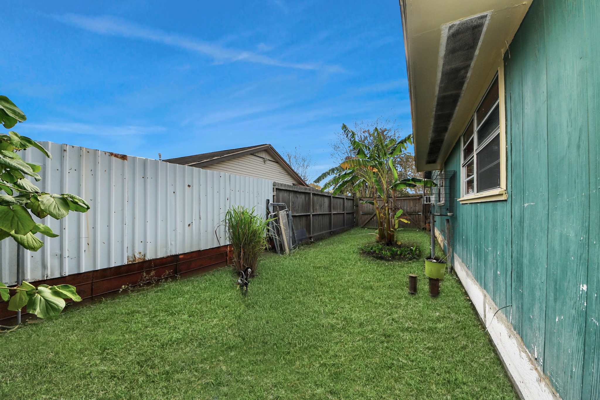 9701 Foredale Street Houston, TX 77075 - Photo 32 of 32 a view of backyard with potted plants and wooden fence