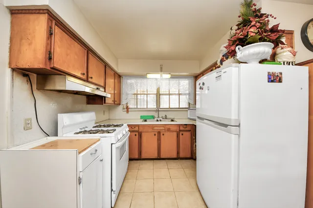 a kitchen with stainless steel appliances a refrigerator sink and cabinets