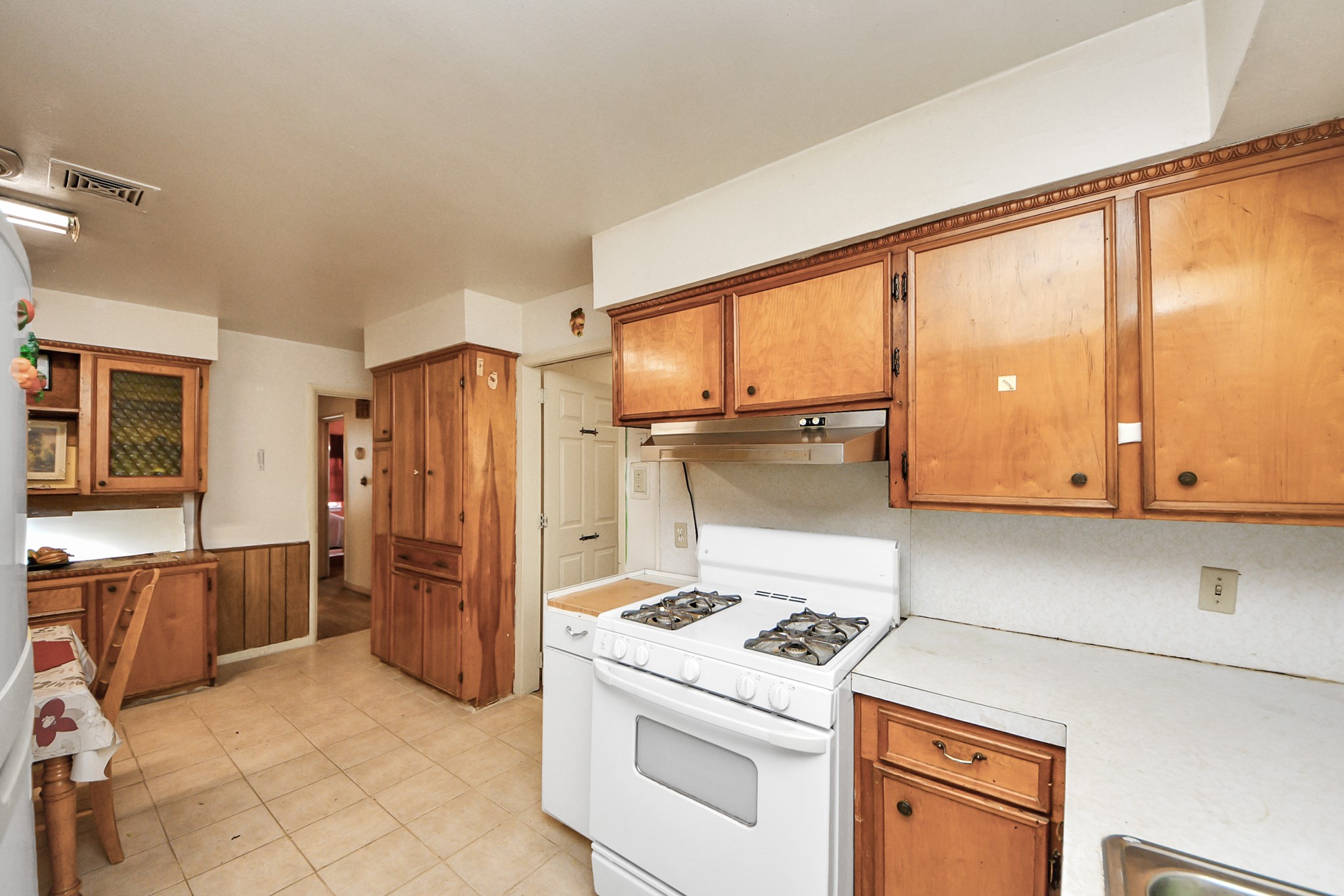 9701 Foredale Street Houston, TX 77075 - Photo 10 of 32 a kitchen with a stove a refrigerator and cabinets